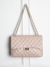 Quilted leather bag with gold details